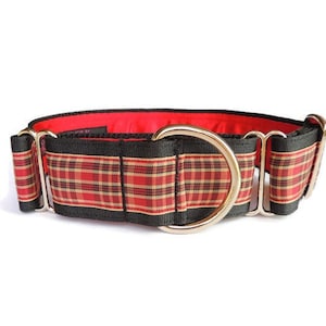 May include: A red and black tartan dog collar with a silver buckle. The collar is made of a thick, durable material and is designed to be comfortable for dogs.