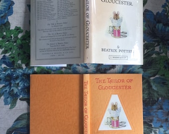 Excellent Scarce Copy of The Tailor of Gloucester by Beatrix Potter with Orange Boards Circa 1940s VG with VG Plus Dust Jacket in Mylar Wrap