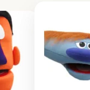May include: Two plush puppets. The first is an orange vertical puppet with black hair, a large purple nose, and a red mouth. The second is a blue horizontal puppet with orange hair, a wide blue nose, and a red mouth with a visible interior.