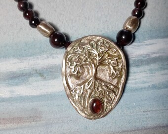 Cetic necklace  :  Yggdrasil in bronze, the Celtic Tree of life with a garnet cab  and real garnet & bronze beads