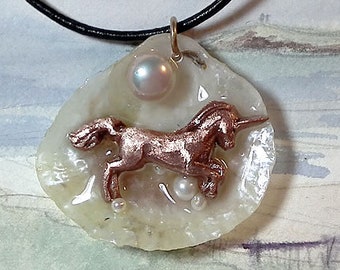 Pendant: handmade copper Unicorn, white-goldy anomia shell +white sweetwater pearl, crystal clear resin gives it an ocean wet  look