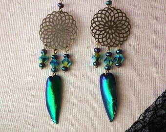Boho style earrings made of   bronze color hooks and filigreestampings  , blue-green beetlewings/elytras & sorted Swarovski  chrystal beads