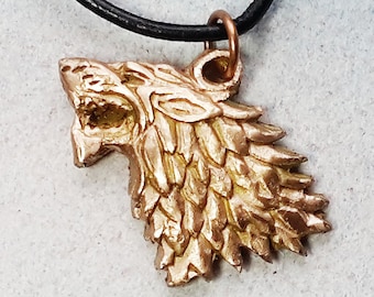 Unisex Pendant, celtic/viking wolf head handmade in goldbronze  or copper  on a black leather strap. For women and men