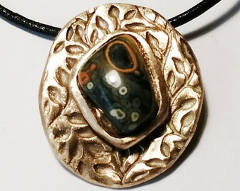 Goldbronze necklace,  art-deco stylewith a cabochon of ocean jasper  on a  black leather cord or black leather band+chain