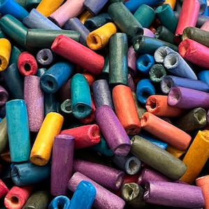 15 Medium, smooth, tube, hand-made ceramic beads in 12 colors.