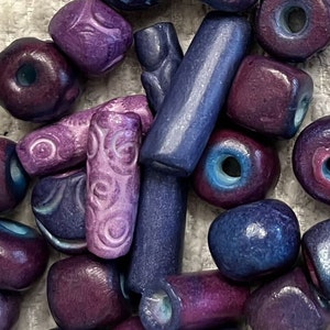 25 Hand-Made Ceramic Beads, Assorted Shapes in Purple shades.