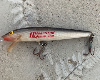 Vintage Fishing Lure Rapala Advertisement- A Heartland Lysine Inc.