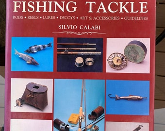 May include: A book cover titled "The Collector's Guide to Antique Fishing Tackle" by Silvio Calabi. The cover features images of antique fishing rods, reels, lures, and accessories. The background is a deep red color.