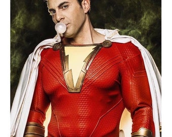 May include: A man dressed as a superhero, wearing a red and gold costume with a white cape, is blowing a bubble with a piece of gum. He has a serious expression on his face.
