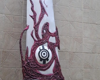 May include: A large, stylized sword prop with a white blade and intricate burgundy-colored organic designs. The hilt is black and wrapped. The blade features a central circular emblem. The text "WAYNE FACTORY COSTUMING STUDIO" is visible.