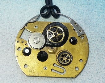 Steampunk  pendant : Gustav Klimt Style, pieces of watch & alarmclock, gears, black polymer resin, Swarovski cabs on a black leather strap