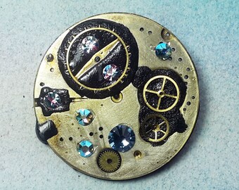 2 in 1, Steampunk brooch/pendant  Gustav Klimt Style ,  pieces of watch, gears, black resin and   blue Swarovski cabs