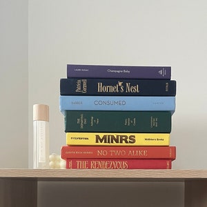 Rainbow book stack, themed books, book decor, pride book stack, interior design, sustainable design, books, stack of books