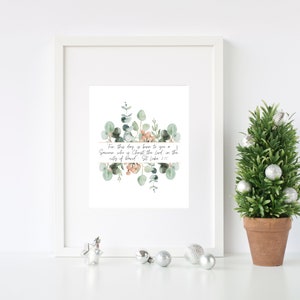 May include: A white framed print with a watercolor illustration of eucalyptus leaves and pink flowers. The print features the text "For this day is born to you a Savior who is Christ the Lord in the city of David - St Luke 2:11"