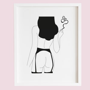 May include: Minimalist black and white art print featuring a line drawing of a figure from the back, wearing lingerie and holding a cigarette. The artwork is framed in a white border, suitable for bedroom or boudoir decor.