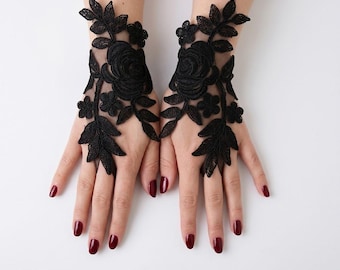 May include: A pair of black fingerless lace gloves featuring intricate floral and leaf embroidery patterns. The design consists of sheer black mesh fabric adorned with detailed rose motifs and small blossoms, extending from the wrist to the fingers.