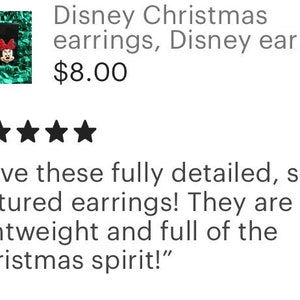 May include: A pair of Christmas-themed earrings featuring Mickey Mouse and Minnie Mouse. The earrings are red, green, and white with a sparkly finish. "Love these fully detailed, soft-textured earrings! They are lightweight and full of the Christmas spirit!"
