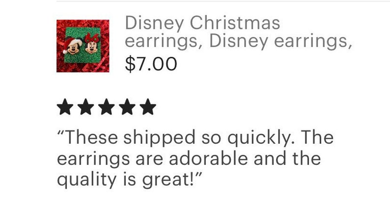 May include: A pair of Christmas-themed earrings featuring Mickey Mouse and Minnie Mouse wearing Santa hats. The earrings are red and green and have a festive feel.