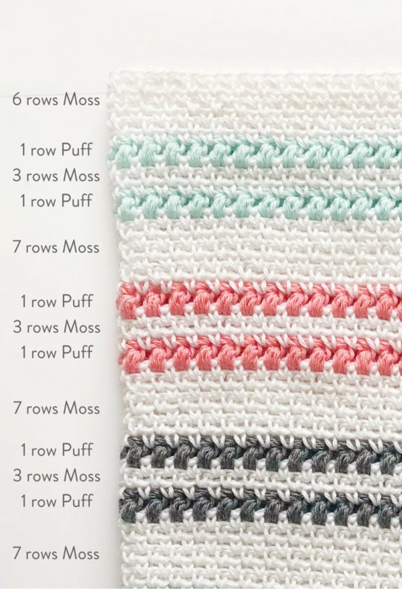 May include: A close-up of a white crocheted fabric with stripes of different colors. The stripes are made of puff stitches and moss stitch. The colors of the stripes are mint green, coral pink, and gray.