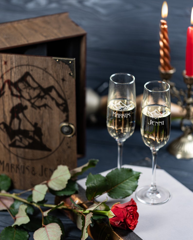 May include: Two champagne flutes with the names "Markus" and "Jenni" etched on them, a single red rose, and a wooden box with the names "Markus & Jenni" on the front.
