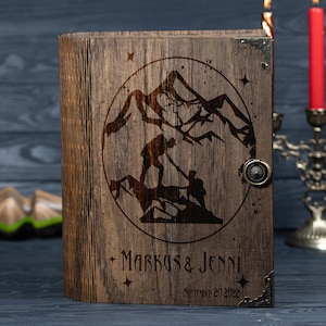 May include: A wooden box with a hinged lid, engraved with a mountain scene and the text "Markus & Jenni September 20, 2022".