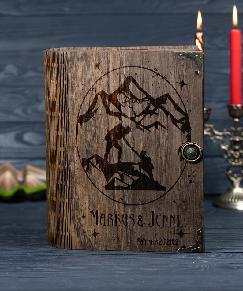 May include: A wooden box with a hinged lid, engraved with a mountain scene and the text "Markus & Jenni September 20, 2022".
