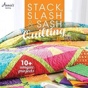 May include: A colorful quilt with a variety of patterns and colors. The quilt is made using the stack, slash, and sash quilting technique. The title "Stack, Slash & Sash Quilting" is printed on the cover of the book. The book also features the text "10+ unique projects".