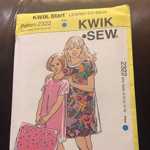 May include: A sewing pattern for a girls' dress. The pattern is called "Kwik Sew" and the pattern number is 2322. The pattern includes sizes 8-10-12-14-16.