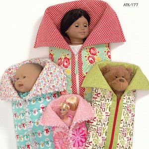 May include: Four sleeping bags for dolls and stuffed animals. The bags are made of different fabrics with various patterns, including floral, snowman, and alphabet designs. The bags have a zipper closure and are labeled "Slumber Party sleeping bags".