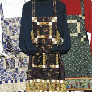May include: Three quilted aprons with different patterns. The apron on the left is blue and white with a floral pattern. The apron in the middle is brown and gold with a floral pattern. The apron on the right is green and white with a floral pattern.