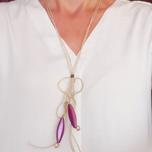 Necklace long lightweight with bronze element and acrylic beads in bright purple.