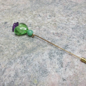Handmade brooch with green murano heart and glass beads in violet color.