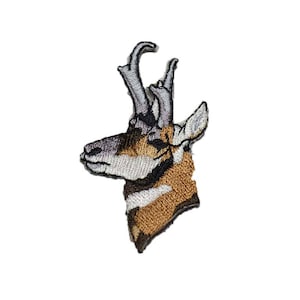 May include: Embroidered patch of a pronghorn antelope with brown and white fur, a black nose, and curved horns.