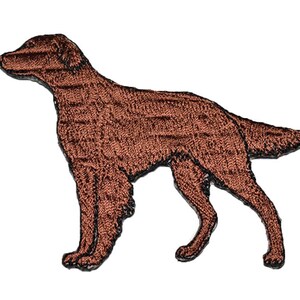 May include: Embroidered patch of a brown Irish Setter dog standing with its head turned to the left. The dog is outlined in black.