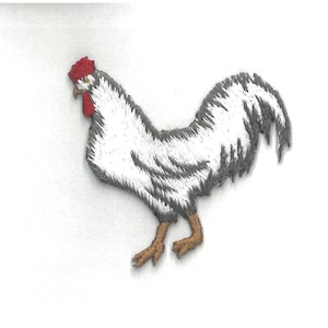 May include: Embroidered patch of a rooster. The rooster is primarily white with gray detailing on the wings and tail. It has a red comb and wattle, and brown legs and feet. The patch is likely for clothing or accessories.
