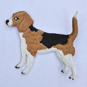 May include: Embroidered iron-on patch of a brown, black, and white beagle dog.