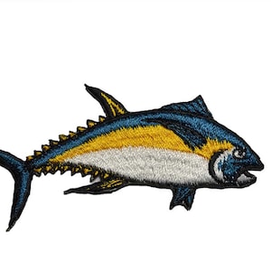 May include: Embroidered iron-on patch of a yellowfin tuna with blue and white details. The tuna is swimming to the right.