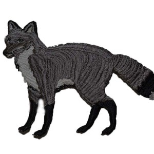 May include: A gray embroidered patch of a fox with a black tail tip.