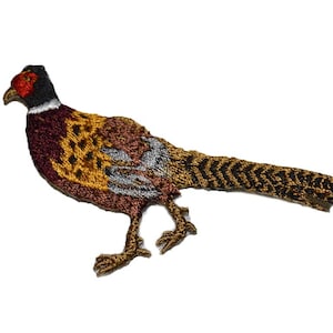 May include: Embroidered iron-on patch of a brown and gold pheasant with a black and white tail.