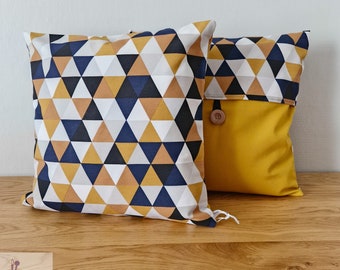 Cushion cover with mustard yellow, gray, black and white geometric patterns