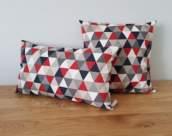 Cushion covers with geometric patterns in red, grey and black