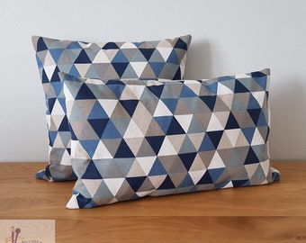 Cushion cover with geometric triangle patterns in predominantly blue