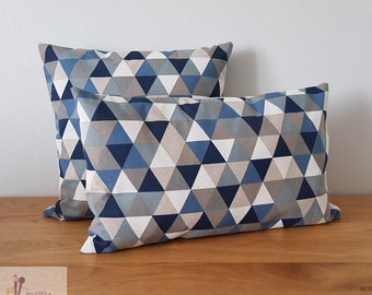 Cushion cover with geometric patterns of triangles predominantly blue