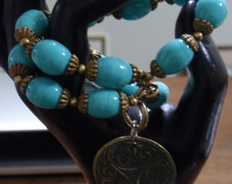 Blue Glass colored bead and brass bracelet