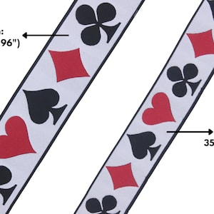 May include: Two white ribbons with black playing card suit symbols printed on them. The ribbon on the left is 1.96 inches wide and the ribbon on the right is 1.37 inches wide.