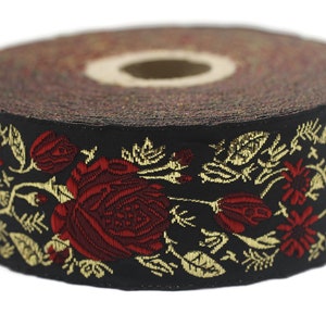 May include: Black ribbon trim with gold and red embroidered floral design. The design features roses and leaves.