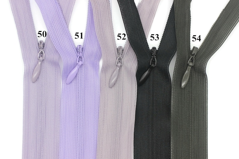 May include: Five zipper pulls in different colors: lavender, light gray, black, dark gray, and brown. The zipper pulls are labeled with numbers 50 through 54.