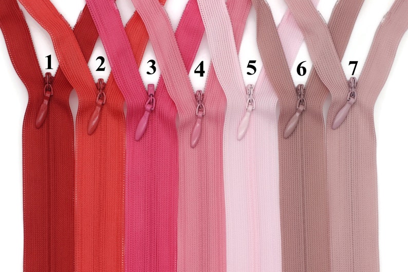 May include: Seven different colors of zipper tape, numbered 1 through 7. The colors are red, orange, pink, light pink, light purple, brown, and beige.