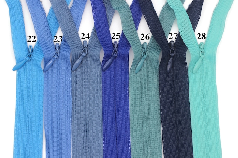 May include: Seven different colors of zipper tape, ranging from light blue to teal. The zippers are labeled with numbers 22 through 28.