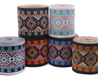 May include: Five spools of colorful patterned trim with geometric designs. The trim is black, red, blue, orange, and gray.